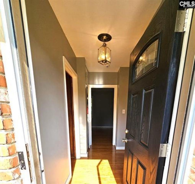 interior space with hardwood / wood-style floors and a notable chandelier