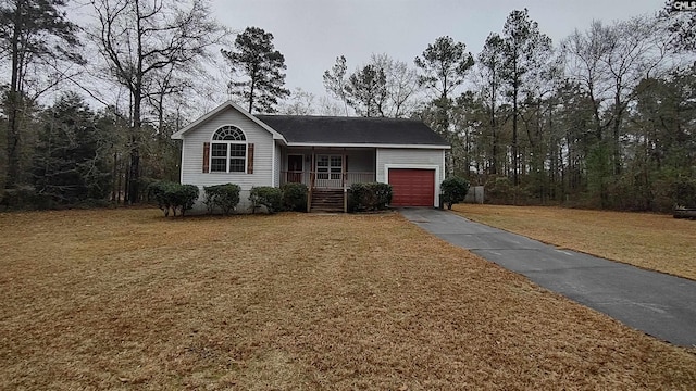 ranch-style house featuring covered porch and a garage