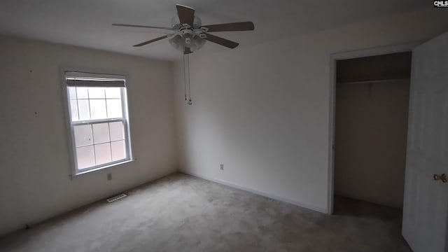 unfurnished bedroom featuring ceiling fan, carpet floors, and a closet