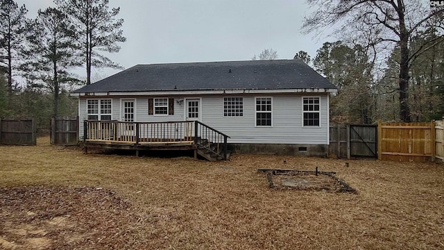 back of property with a wooden deck