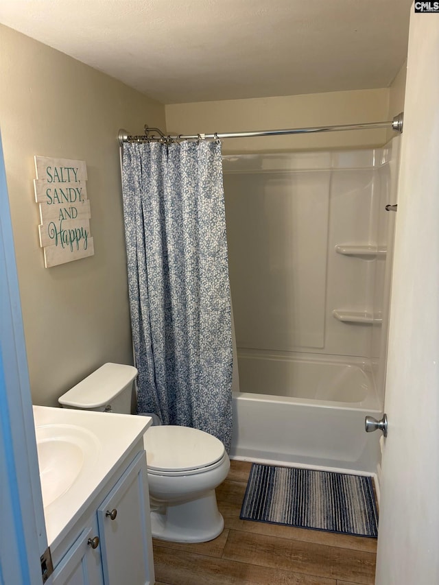 full bathroom with hardwood / wood-style floors, vanity, toilet, and shower / bath combo