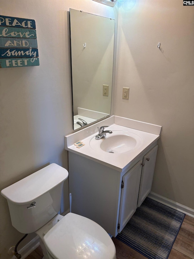 bathroom featuring hardwood / wood-style floors, vanity, and toilet