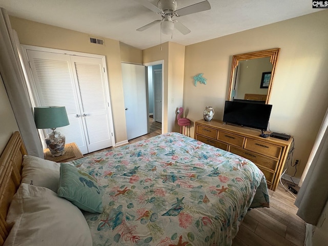 bedroom featuring a closet, light hardwood / wood-style flooring, and ceiling fan