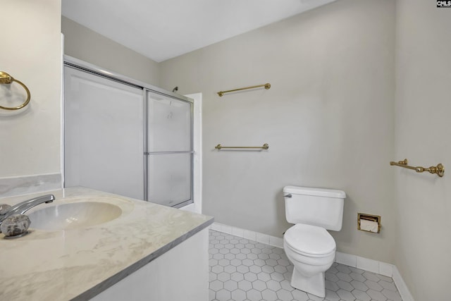 bathroom featuring tile patterned floors, vanity, toilet, and an enclosed shower