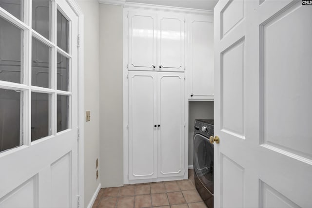 laundry area with cabinets, light tile patterned floors, and washer / clothes dryer