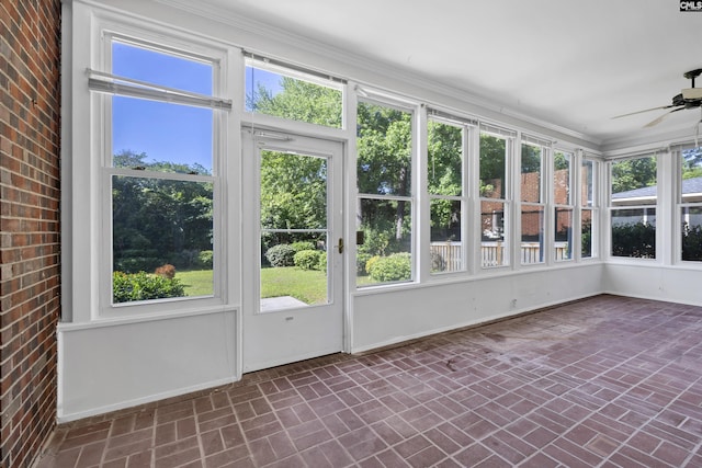 unfurnished sunroom featuring ceiling fan