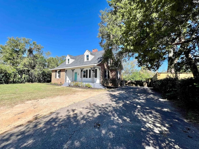 cape cod-style house with a porch and a front yard