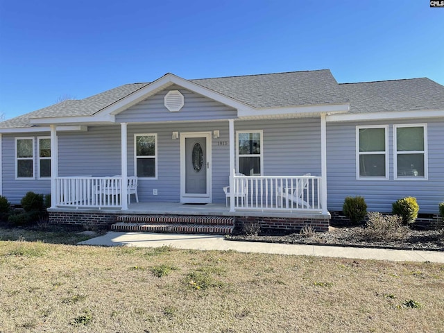 view of front of home featuring a porch and a front lawn