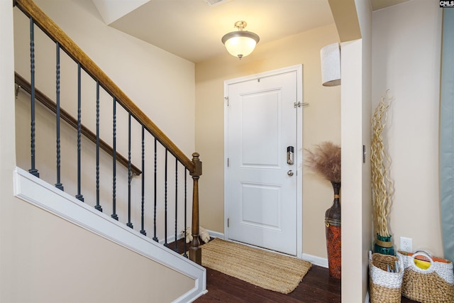 entryway with dark hardwood / wood-style floors