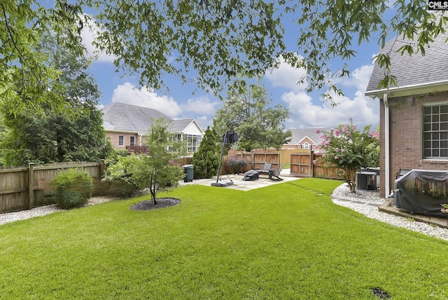 view of yard featuring a patio and central air condition unit