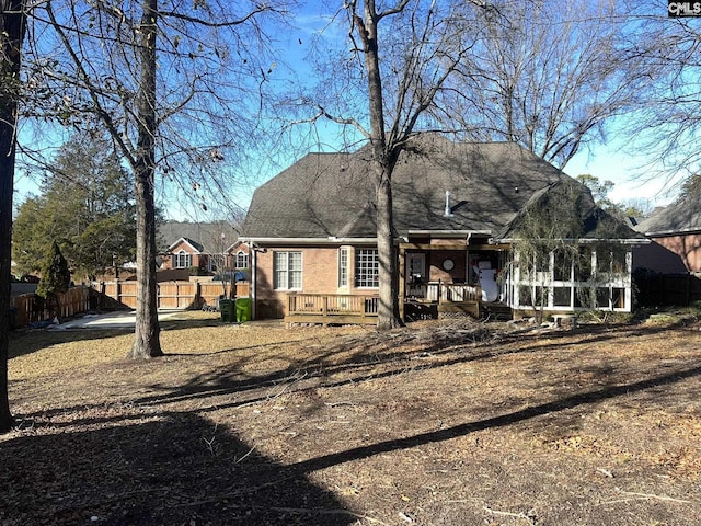 back of house with a deck