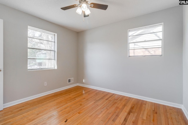 spare room featuring ceiling fan and light hardwood / wood-style flooring