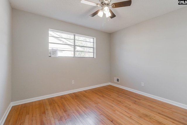 empty room with ceiling fan and light hardwood / wood-style floors