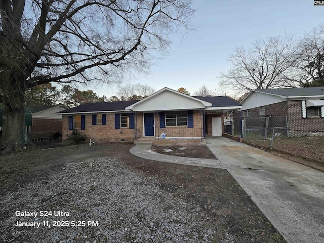 ranch-style house featuring covered porch and a carport