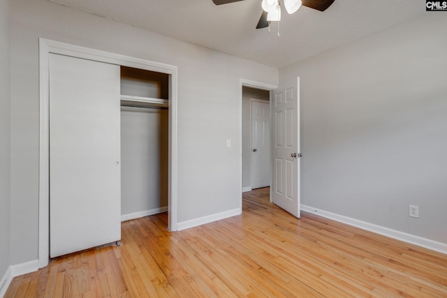 unfurnished bedroom with ceiling fan, a closet, and light hardwood / wood-style flooring