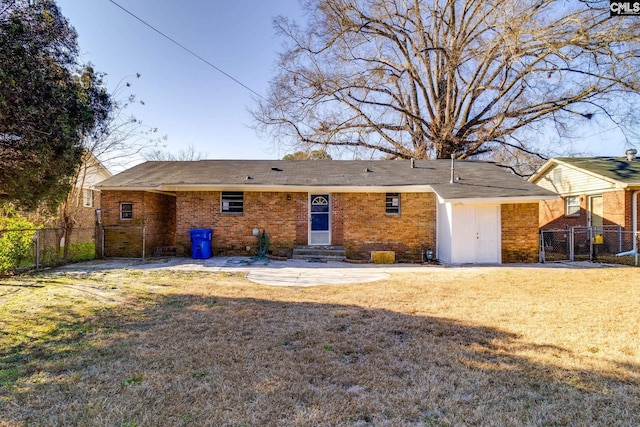 rear view of house with a yard and a patio