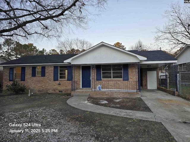 single story home featuring a carport and covered porch