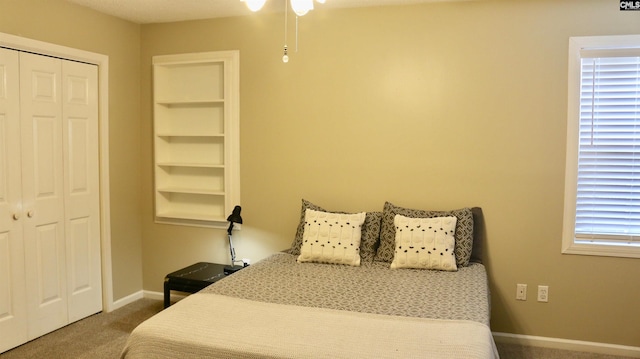 bedroom featuring carpet, a closet, and baseboards