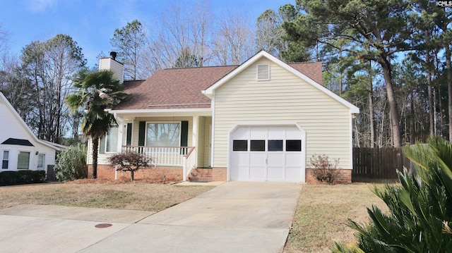 view of front of house featuring a porch, a garage, fence, driveway, and a chimney