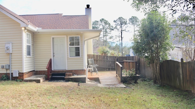 exterior space featuring entry steps, a fenced backyard, and a wooden deck