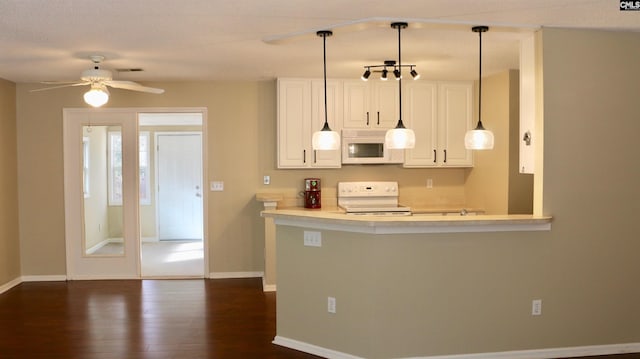 kitchen with white appliances, visible vents, white cabinets, dark wood-type flooring, and light countertops