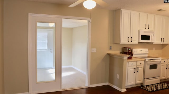 kitchen with white appliances, baseboards, dark wood-style floors, light countertops, and white cabinetry