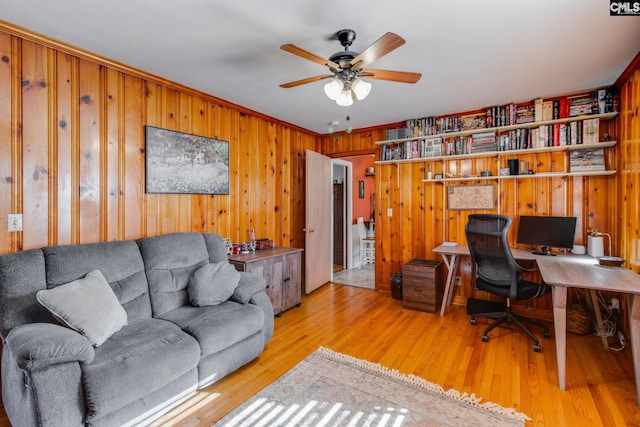 home office with ceiling fan and light hardwood / wood-style floors