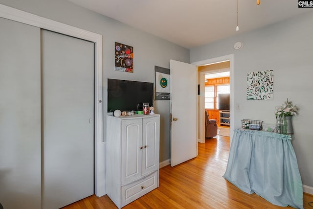 bedroom with light wood-type flooring and a closet