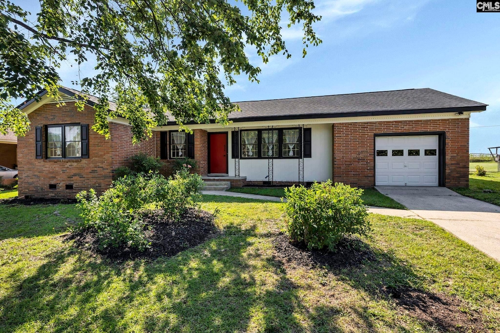 single story home featuring a front lawn and a garage