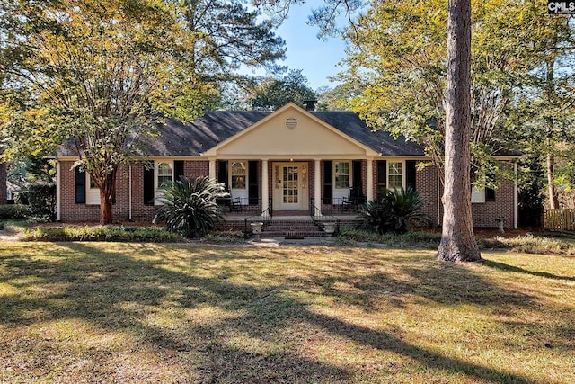 view of front of house featuring covered porch and a front lawn