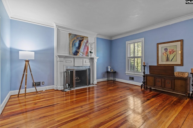 living room with hardwood / wood-style flooring, a high end fireplace, and crown molding