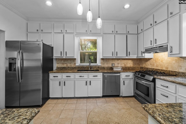 kitchen featuring light tile patterned floors, appliances with stainless steel finishes, white cabinetry, and pendant lighting