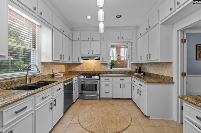 kitchen featuring sink, light tile patterned flooring, white cabinetry, hanging light fixtures, and appliances with stainless steel finishes