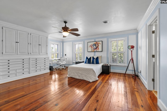 unfurnished bedroom featuring ceiling fan, ornamental molding, hardwood / wood-style flooring, and multiple windows