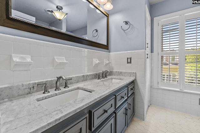 bathroom featuring tile walls, tile patterned floors, vanity, and a healthy amount of sunlight