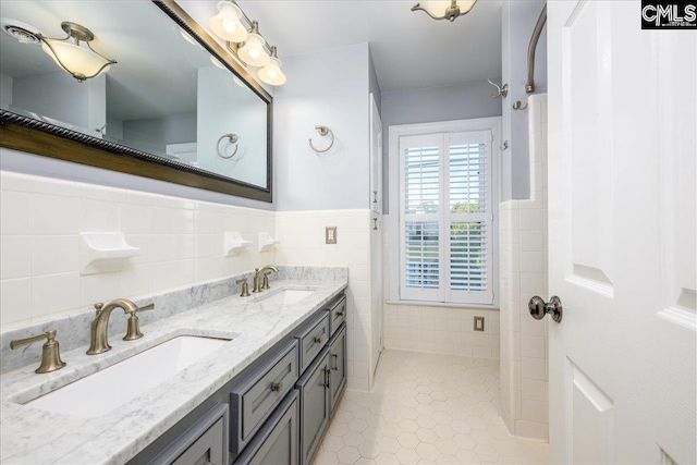 bathroom with tile walls, tile patterned floors, and vanity