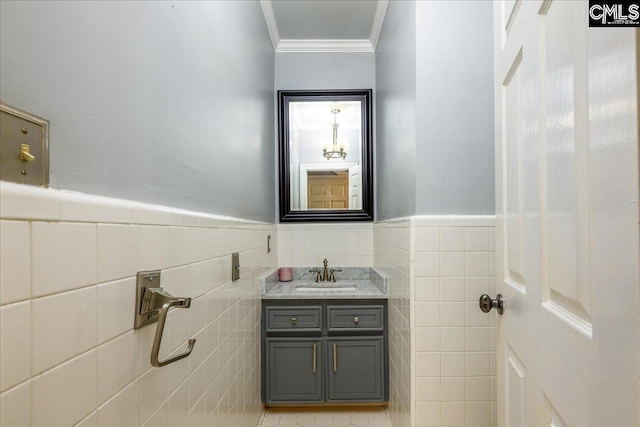 bathroom with vanity, tile walls, tile patterned floors, and crown molding