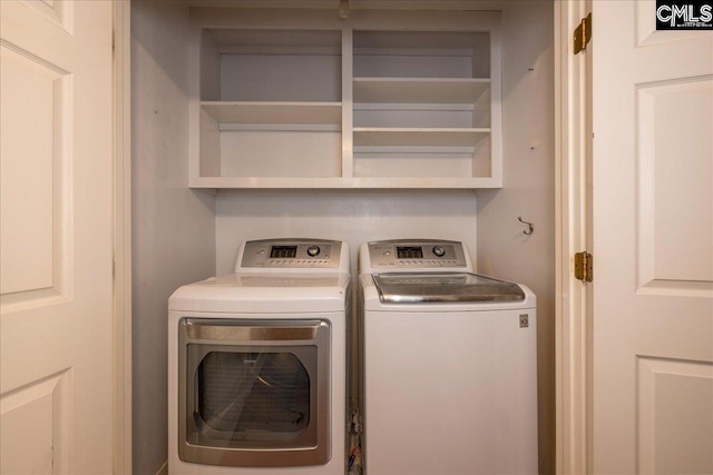 washroom featuring washing machine and dryer