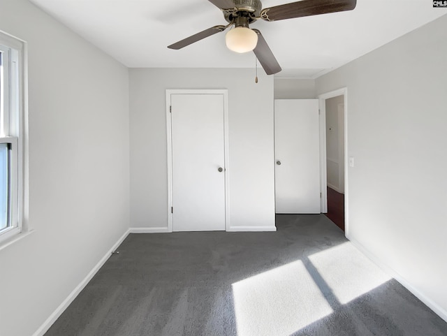 unfurnished bedroom featuring ceiling fan and a closet