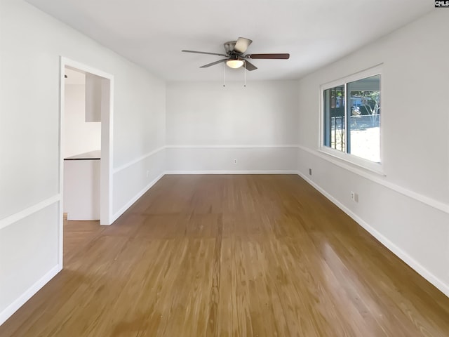 unfurnished room with ceiling fan and hardwood / wood-style floors