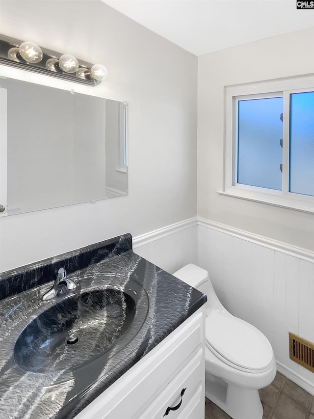 bathroom with tile patterned floors, vanity, and toilet