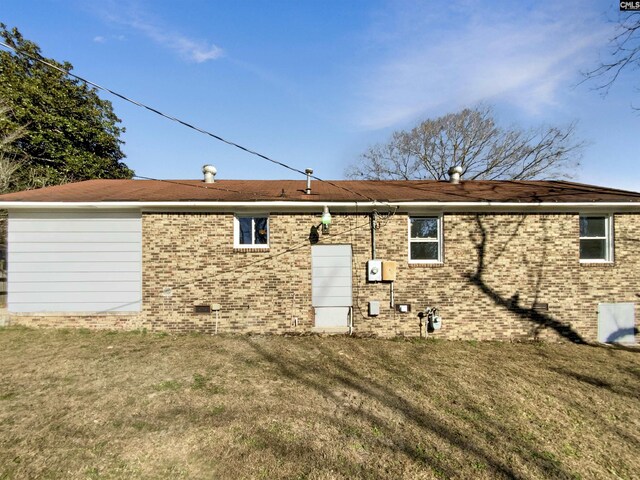 rear view of house with a lawn