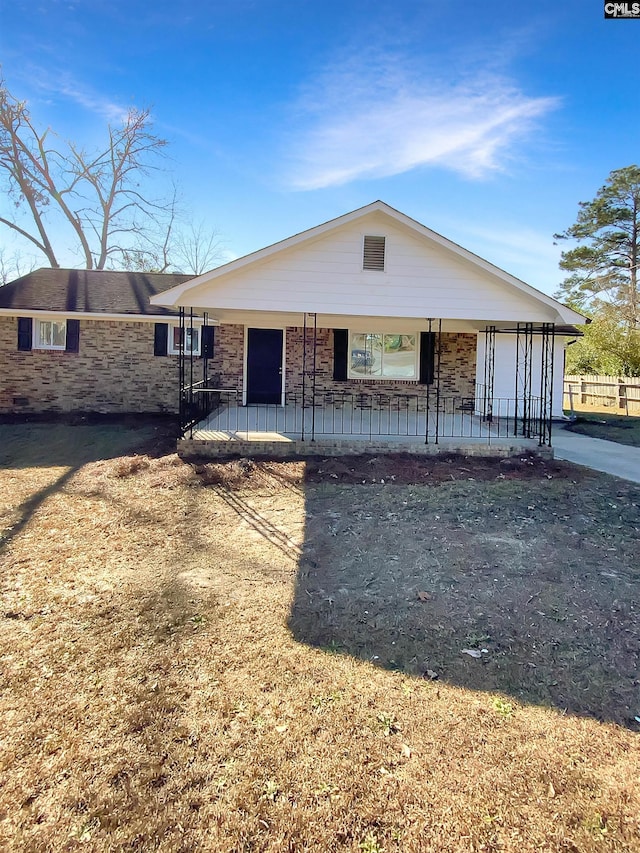 view of front facade with a front lawn, a porch, and a garage