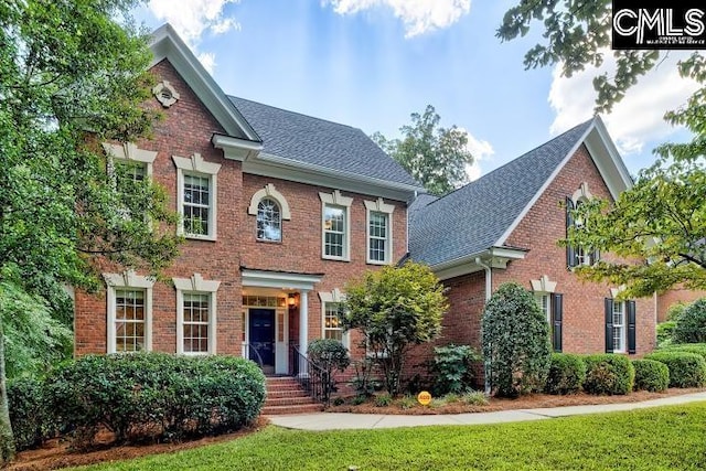 colonial home with a front yard