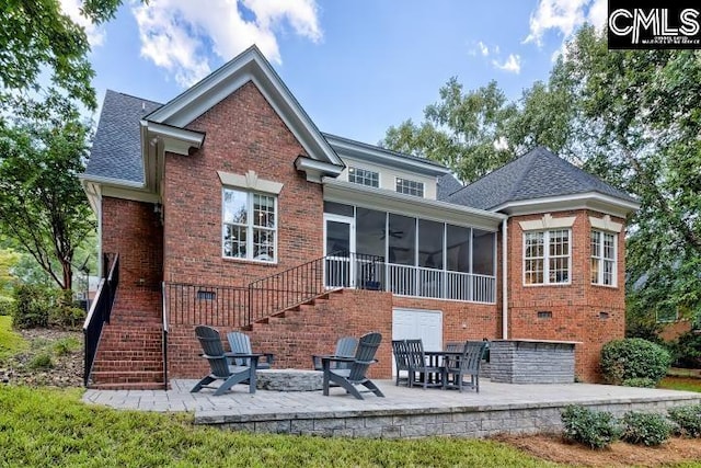 rear view of house with a sunroom and a patio area