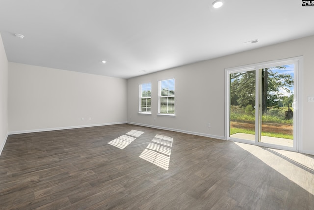 spare room featuring dark wood-type flooring