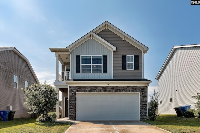 front facade featuring a front yard, a balcony, and a garage