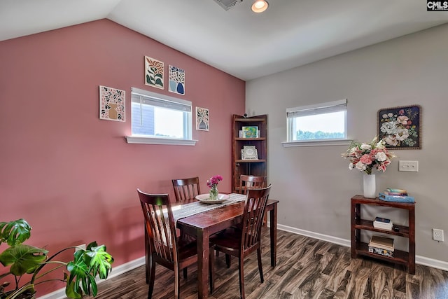 dining area with vaulted ceiling and dark hardwood / wood-style floors