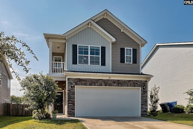 view of front of property featuring a front yard, a balcony, and a garage