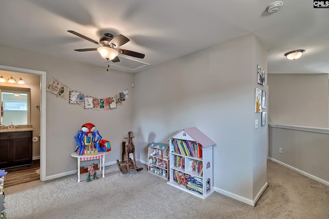 recreation room with light carpet and ceiling fan